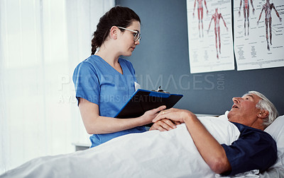 Buy stock photo High angle shot of a female carer assisting her male patient in a nursing home