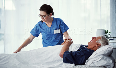 Buy stock photo Cropped shot of a female carer assisting her male patient in a nursing home