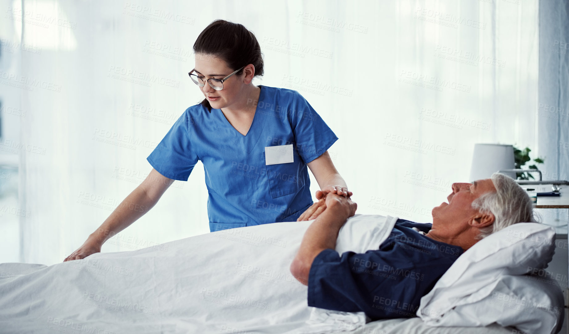 Buy stock photo Cropped shot of a female carer assisting her male patient in a nursing home