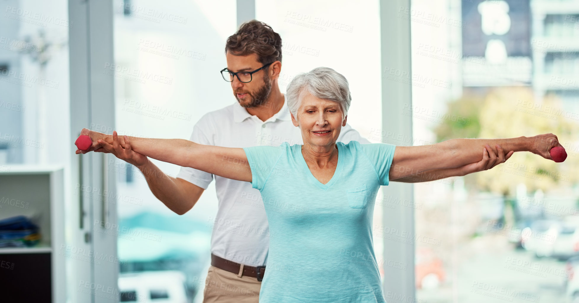 Buy stock photo Cropped shot of a senior woman working through her recovery with a male physiotherapist