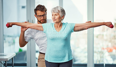 Buy stock photo Cropped shot of a senior woman working through her recovery with a male physiotherapist