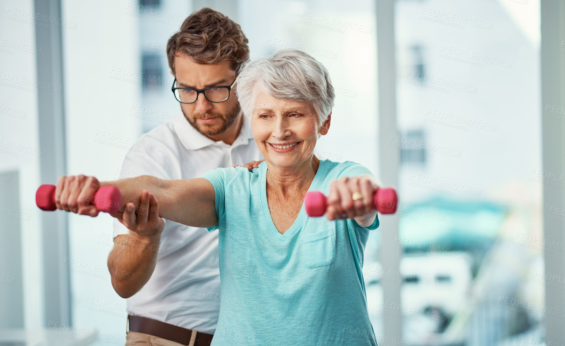 Buy stock photo Cropped shot of a senior woman working through her recovery with a male physiotherapist