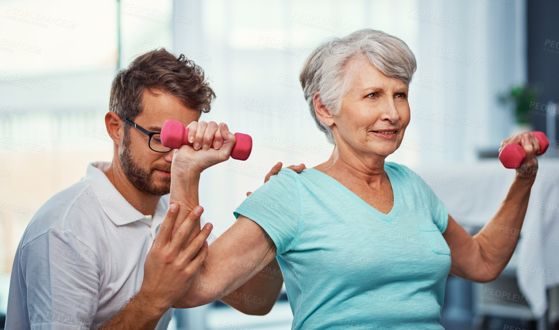 Buy stock photo Cropped shot of a senior woman working through her recovery with a male physiotherapist