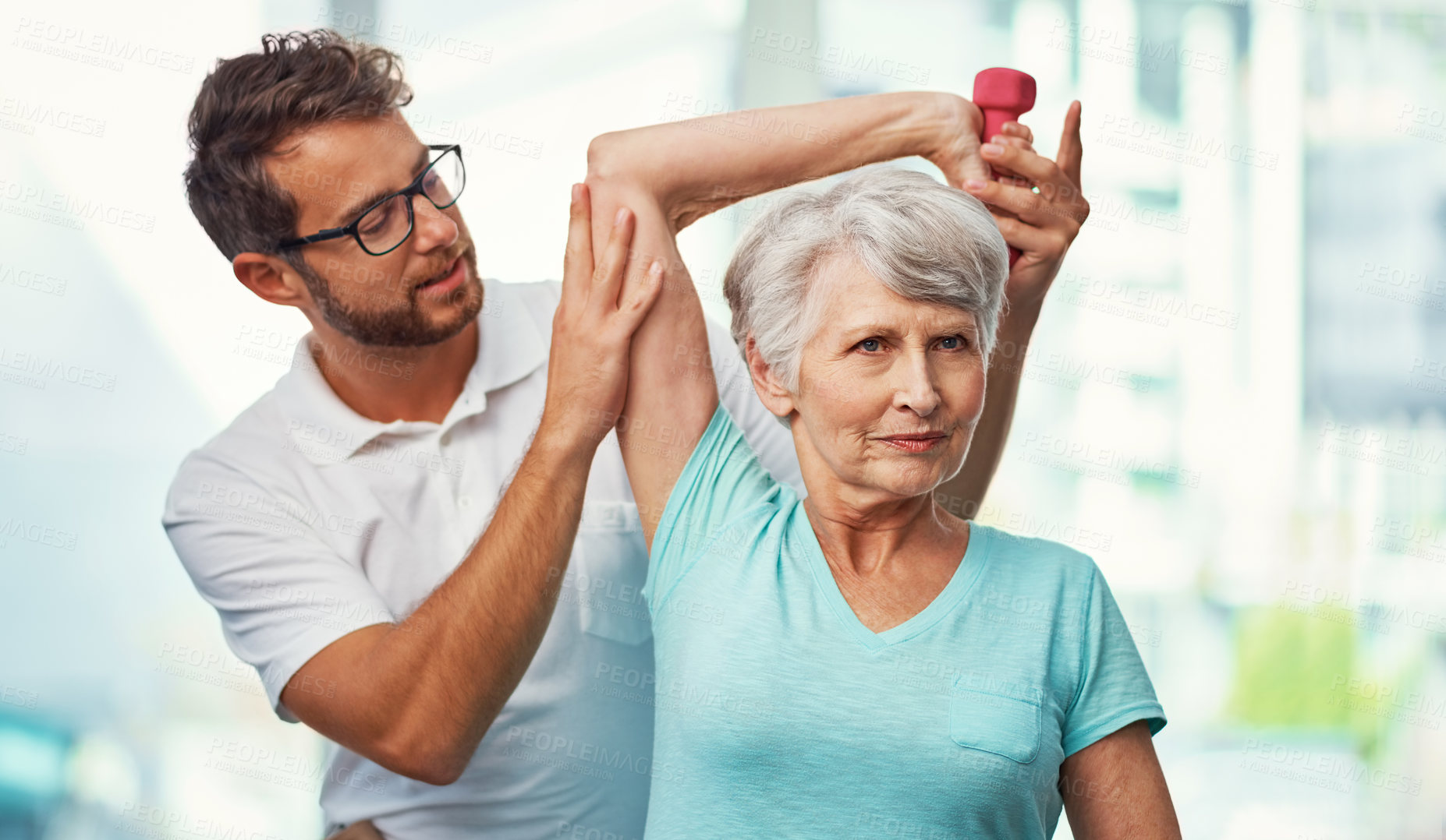 Buy stock photo Cropped shot of a senior woman working through her recovery with a male physiotherapist