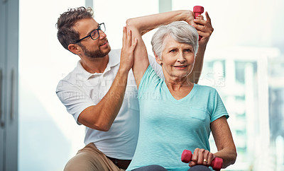 Buy stock photo Cropped shot of a senior woman working through her recovery with a male physiotherapist