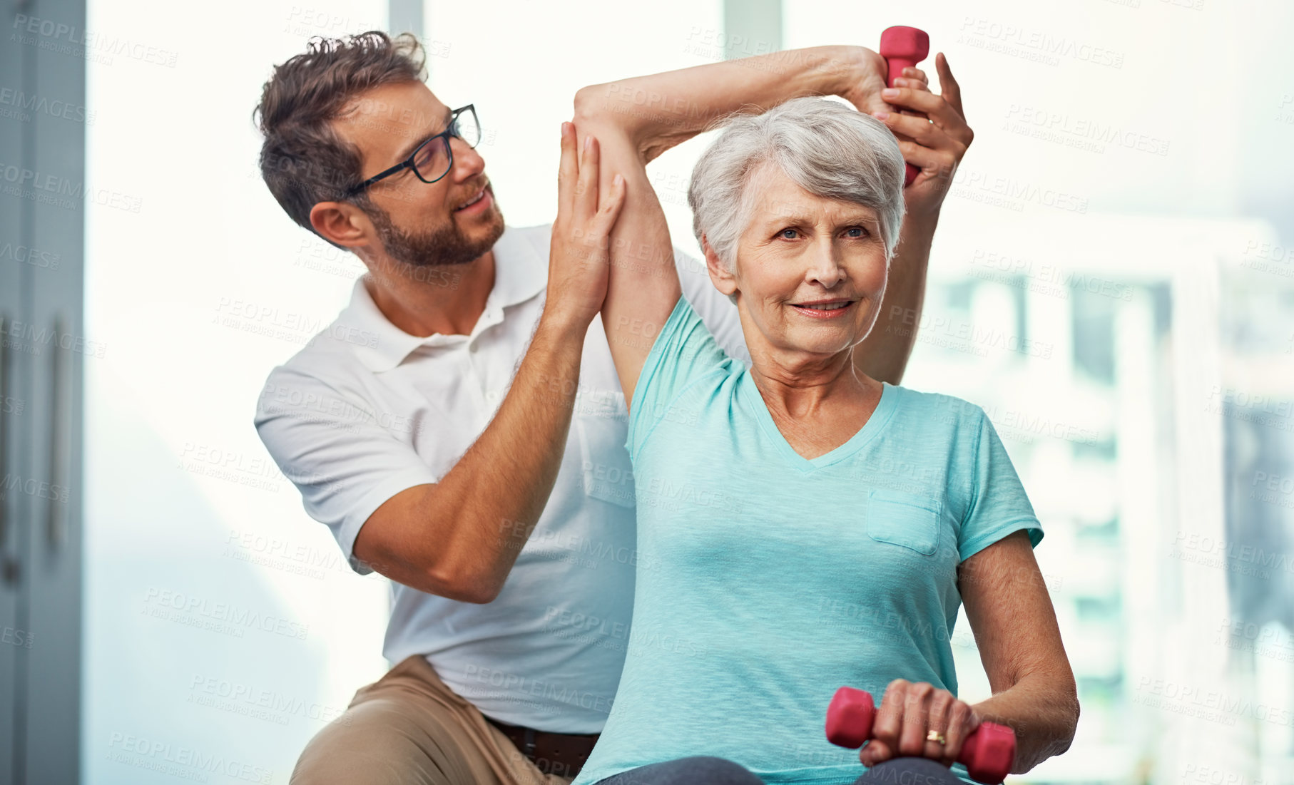 Buy stock photo Cropped shot of a senior woman working through her recovery with a male physiotherapist