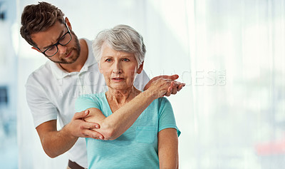 Buy stock photo Cropped shot of a senior woman working through her recovery with a male physiotherapist