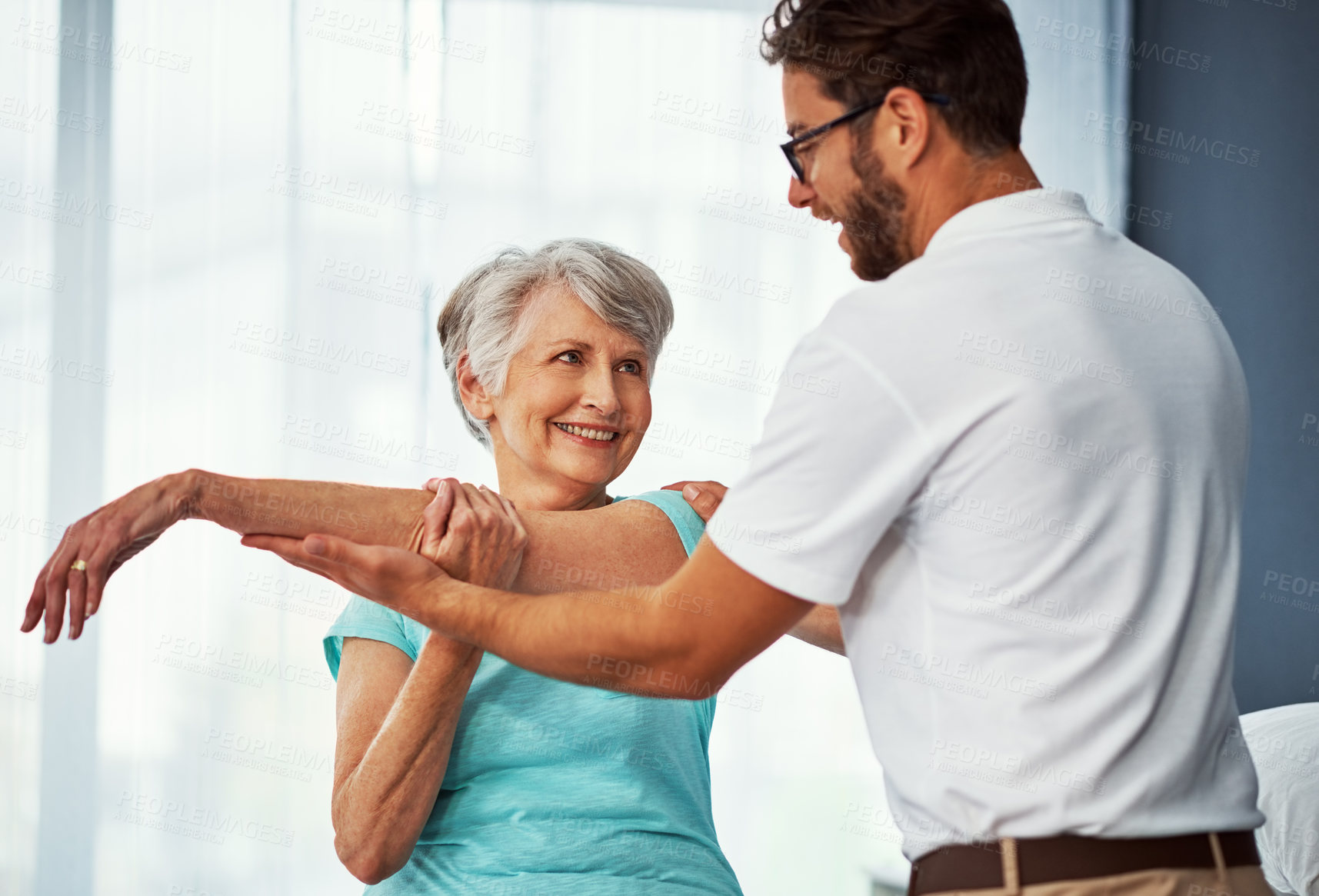 Buy stock photo Cropped shot of a senior woman working through her recovery with a male physiotherapist