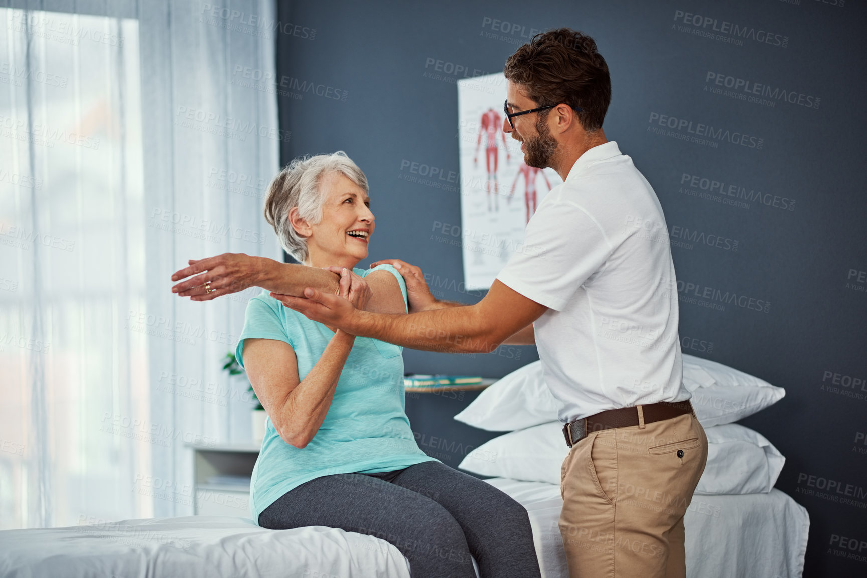 Buy stock photo Smile, old woman and stretching with physiotherapy in clinic for mobility, muscle exercise or recovery. Man, help and elderly person for physical therapy, injury assessment and medical rehabilitation