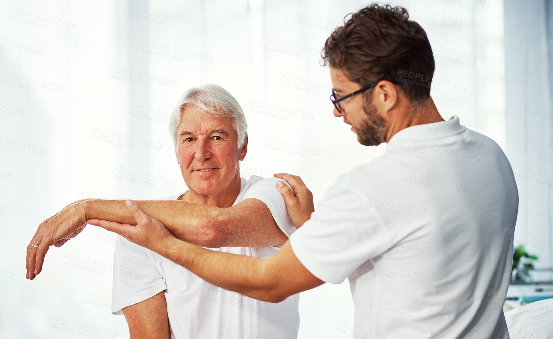 Buy stock photo Senior man, physiotherapist and checkup with arm for muscle recovery or healing therapy in clinic. Elderly, male person or physiotherapy with patient for healthcare or rehabilitation in practice