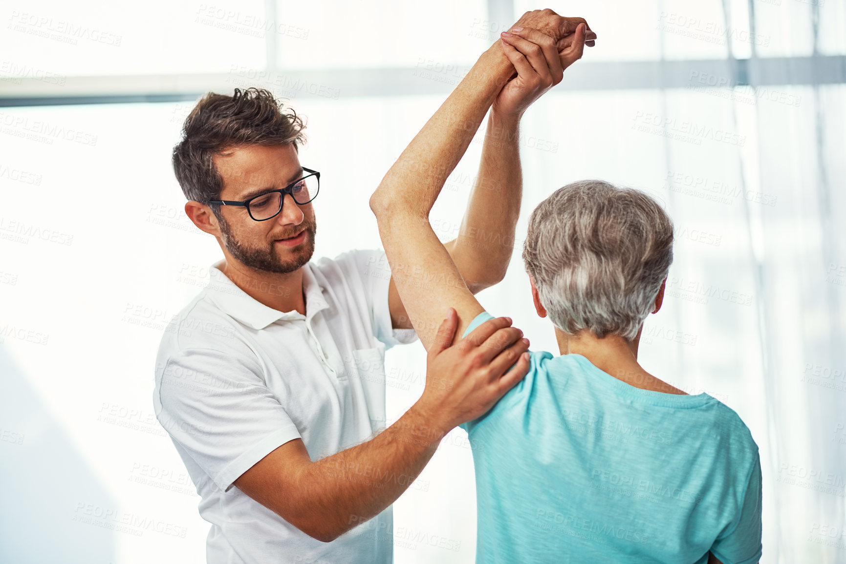 Buy stock photo Cropped shot of a senior woman working through her recovery with a male physiotherapist