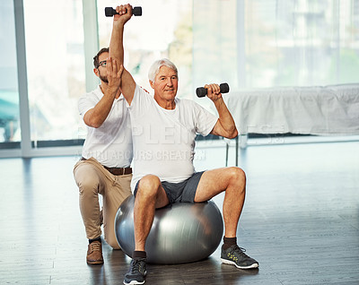 Buy stock photo Full length shot of a senior man working on his recovery with a male physiotherapist