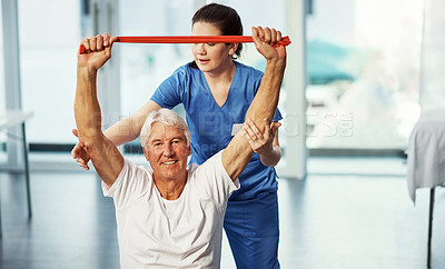 Buy stock photo Cropped portrait of a senior man working on his recovery with a female physiotherapist