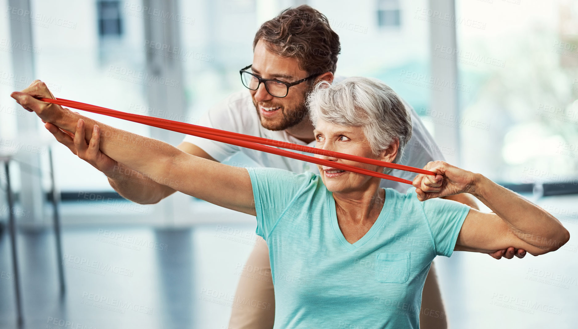 Buy stock photo Cropped shot of a senior woman working through her recovery with a male physiotherapist