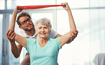 Buy stock photo Cropped portrait of a senior woman working through her recovery with a male physiotherapist