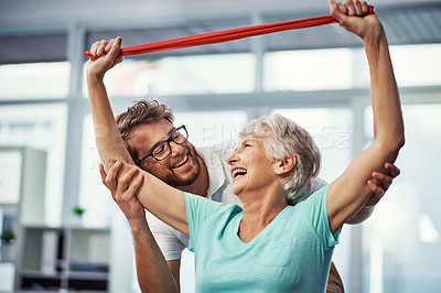 Buy stock photo Cropped shot of a senior woman working through her recovery with a male physiotherapist