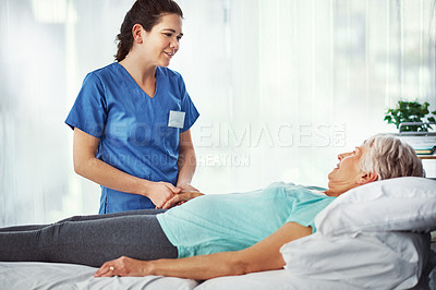 Buy stock photo Cropped shot of a young female carer assisting her senior patient in the hospital