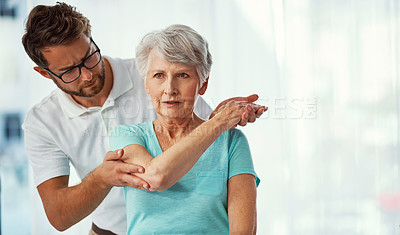 Buy stock photo Cropped shot of a senior woman working through her recovery with a male physiotherapist