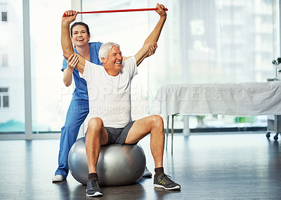 Buy stock photo Full length shot of a senior man working on his recovery with a female physiotherapist