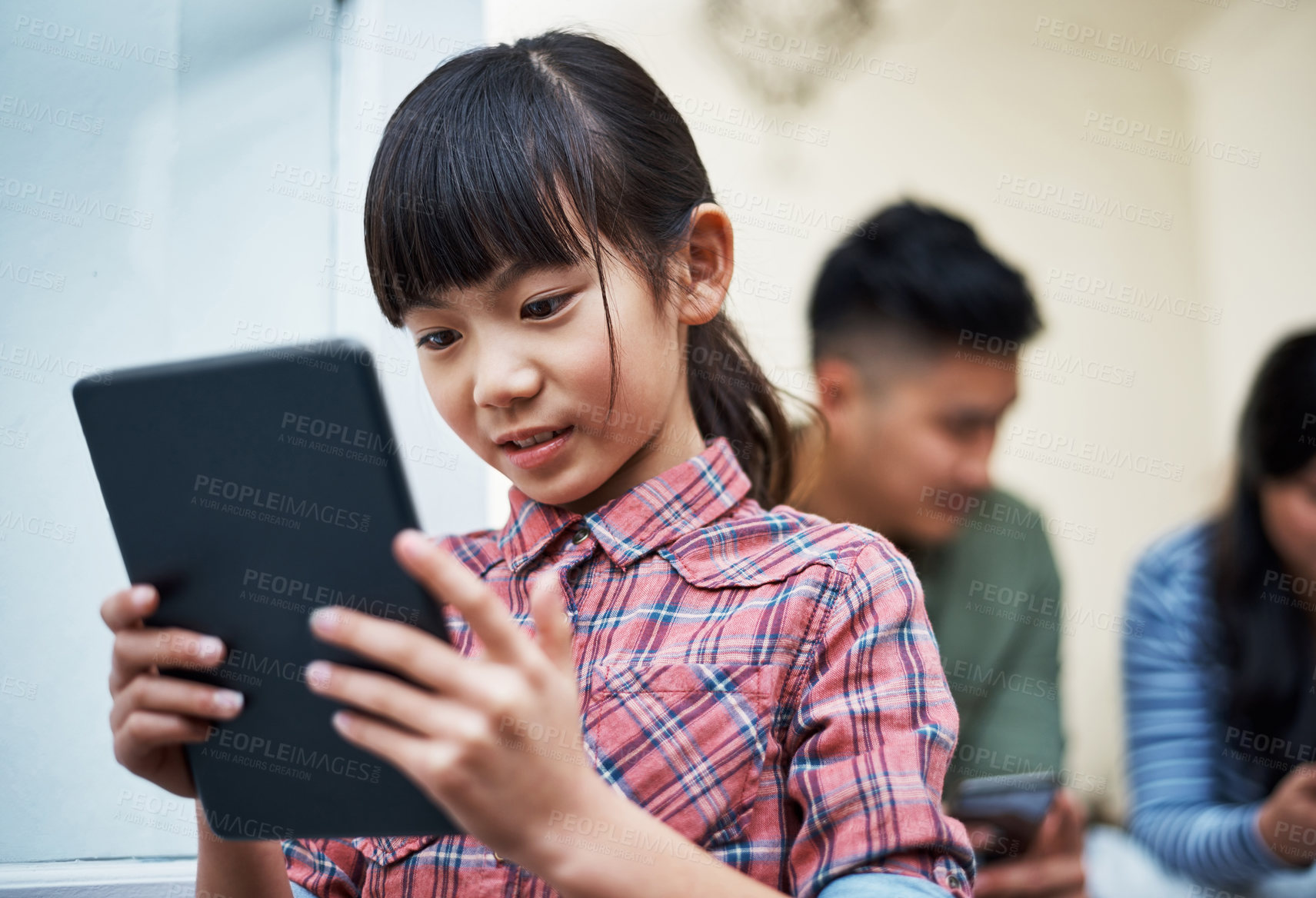 Buy stock photo Shot of a little girl using a digital tablet at home