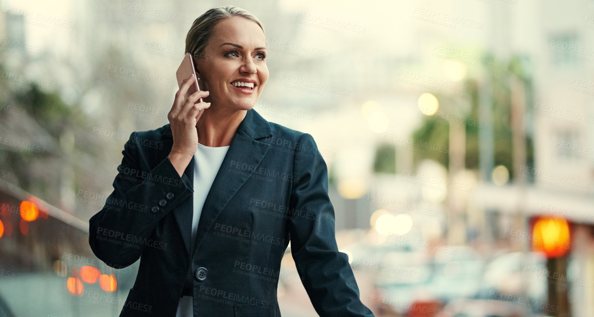 Buy stock photo Cropped shot of an attractive mature businesswoman using her cellphone while standing on the balcony of her office