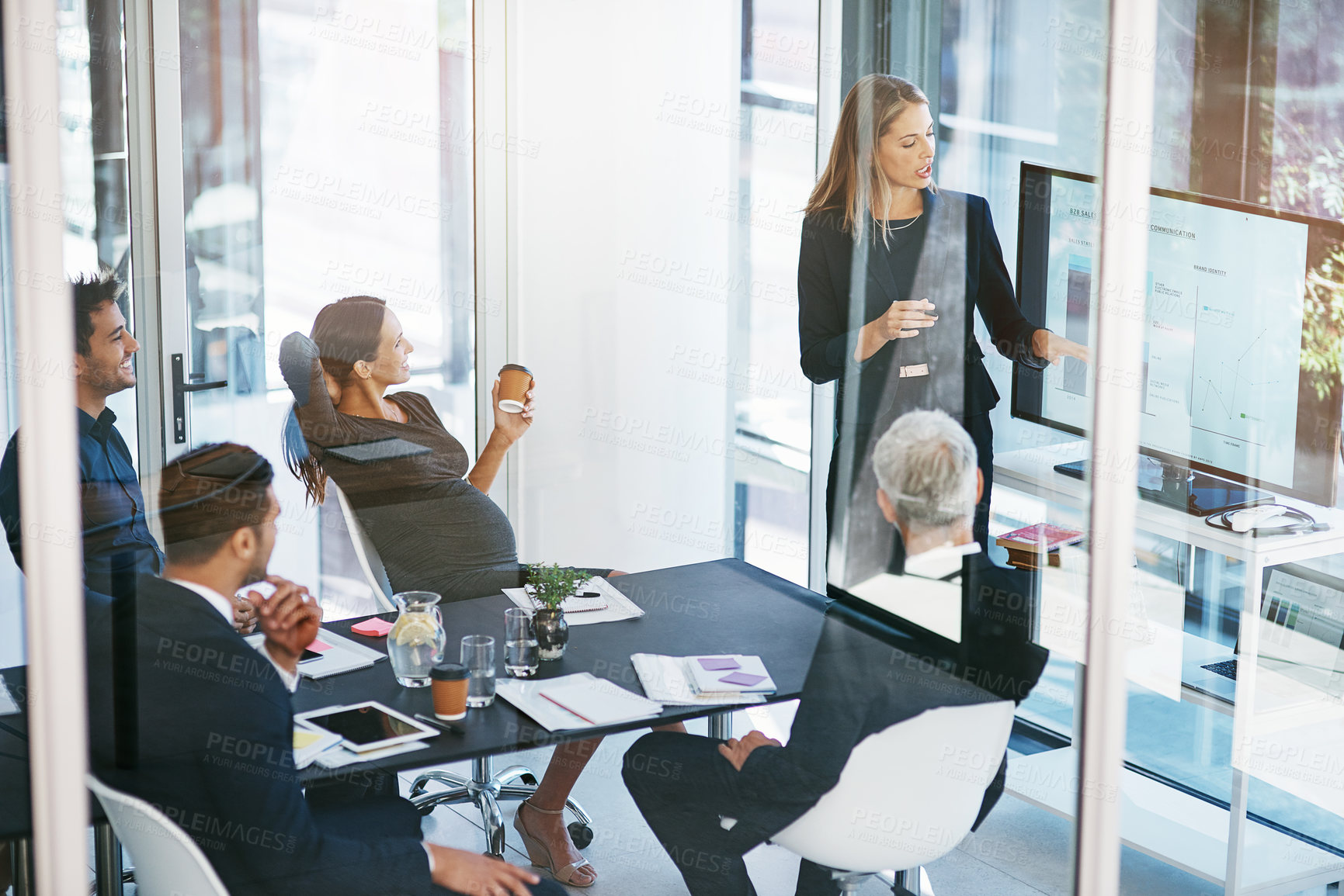 Buy stock photo High angle shot of a young businesswoman giving a presentation in the boardroom