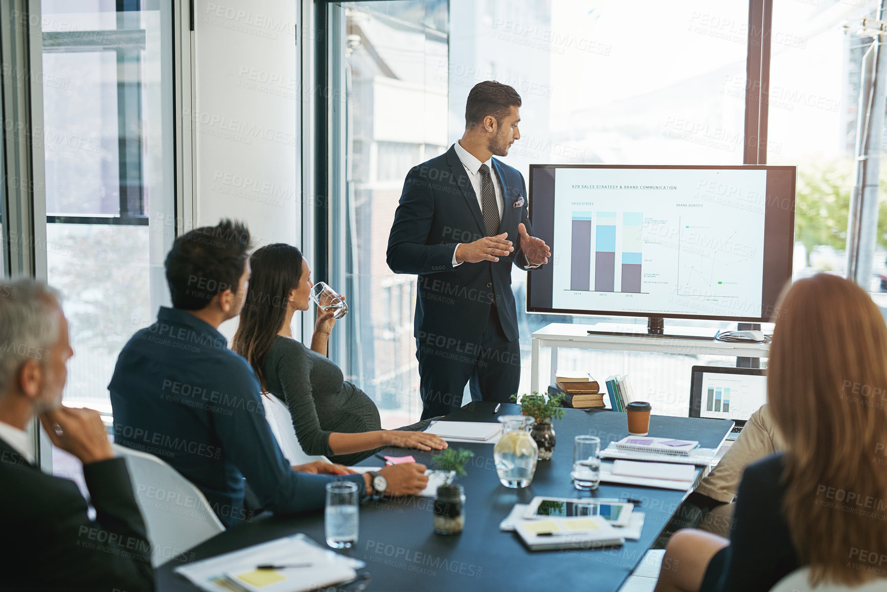 Buy stock photo Cropped shot of a young businessman giving a presentation in the boardroom