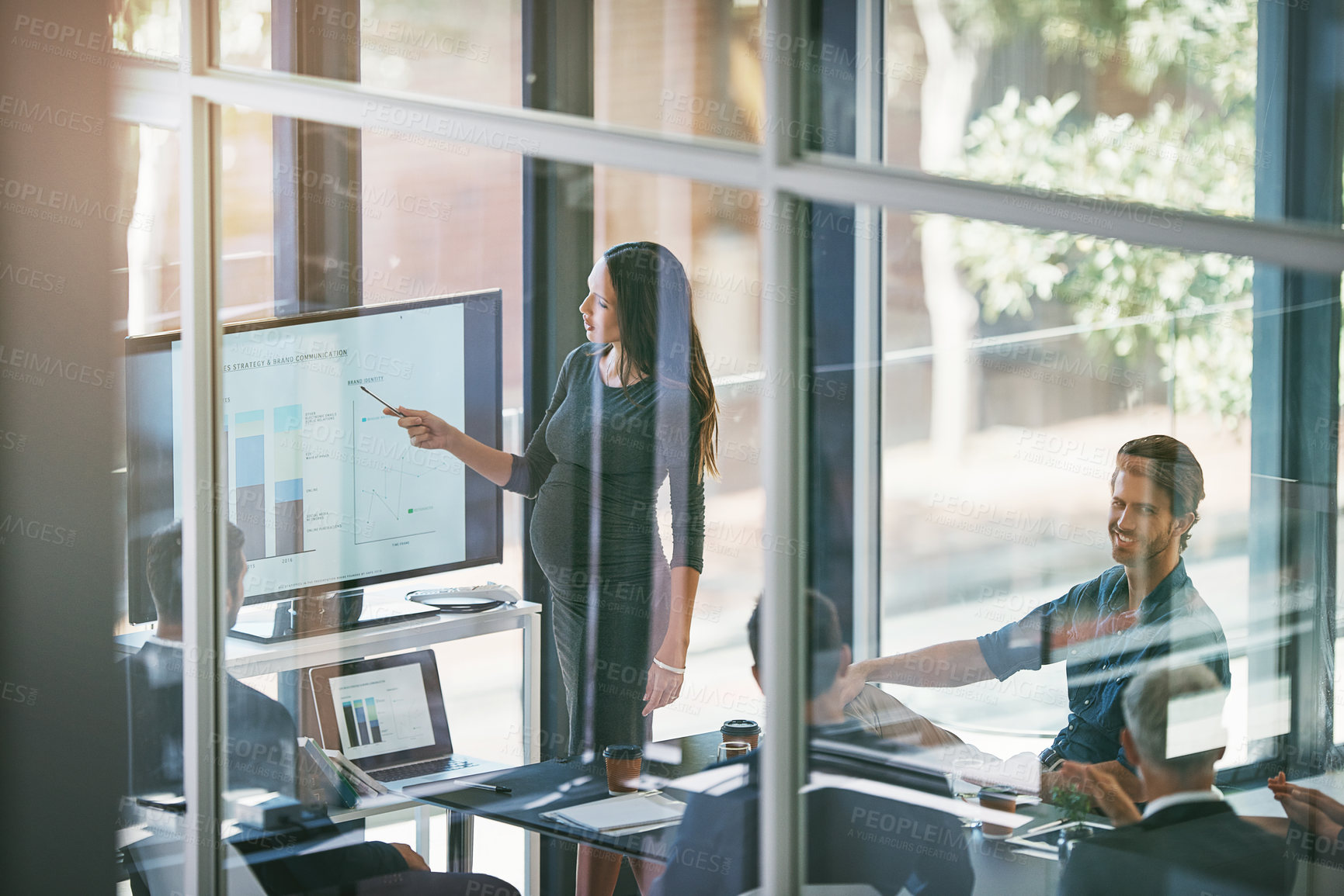 Buy stock photo High angle shot of a pregnant businesswoman giving a presentation in the boardroom