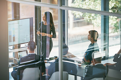 Buy stock photo High angle shot of a pregnant businesswoman giving a presentation in the boardroom