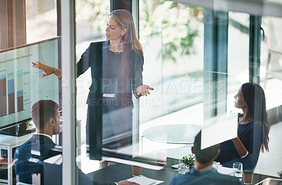 Buy stock photo High angle shot of a young businesswoman giving a presentation in the boardroom