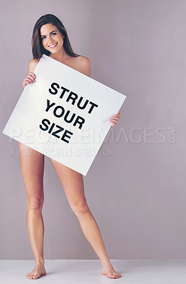 Buy stock photo Body positivity, poster and portrait of naked woman in studio with empowerment or motivation sign. Self love, happy and female person with board for inspiration or confidence by gray background.