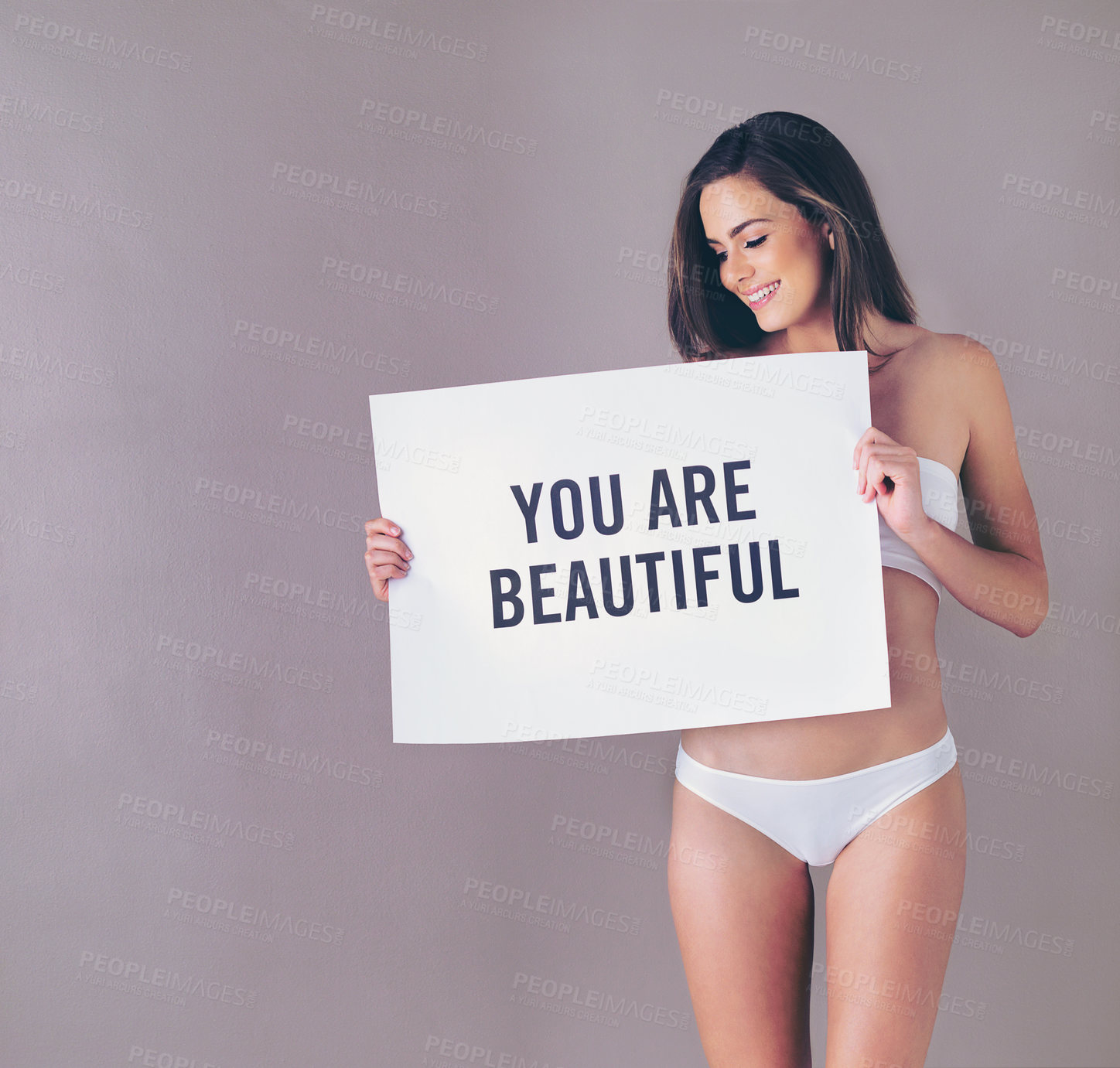 Buy stock photo Body positivity, smile and woman with poster in studio with empowerment, self love or motivation sign. Underwear, happy and female person with board for inspiration or confidence by gray background.