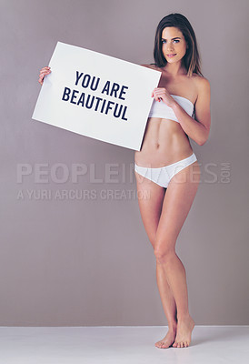 Buy stock photo Body positivity, beauty poster and portrait of woman in studio with empowerment or motivation sign. Self love, underwear and female person with board for inspiration or confidence by gray background.