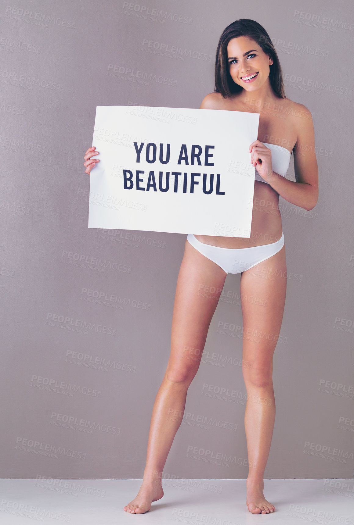 Buy stock photo Body positivity, board and portrait of woman in studio with empowerment, self love or motivation sign. Underwear, happy and female person with poster for inspiration or confidence by gray background.