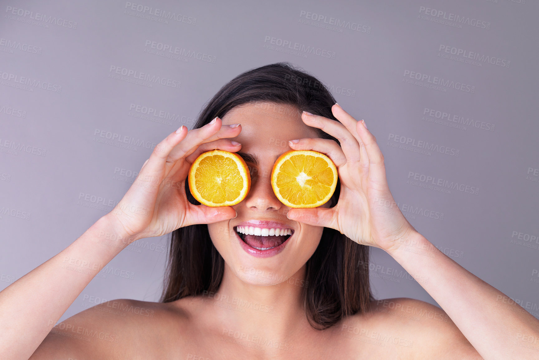 Buy stock photo Orange, skincare and woman in studio with natural, organic and vitamin c routine for glow. Health, smile and person with citrus fruit for dermatology treatment for face brightening by gray background