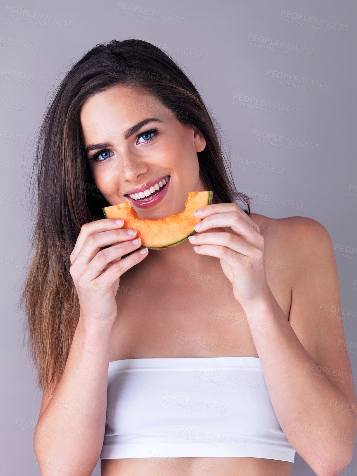 Buy stock photo Portrait, woman and smile with melon in studio for organic nutrition, vegan and healthy diet. Happy, female person and face with cantaloupe on white background for antioxidant, benefits and vitamin c