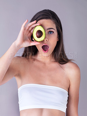 Buy stock photo Avocado, surprise and woman in studio with skincare, organic and natural face routine for glow. Health, shock and person with fruit for dermatology treatment for moisturizing by white background.