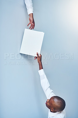Buy stock photo Teamwork, paper and giving in space on background, document or paperwork for career collaboration. Man, advertising or marketing with mockup for workforce, assistance and professional with file