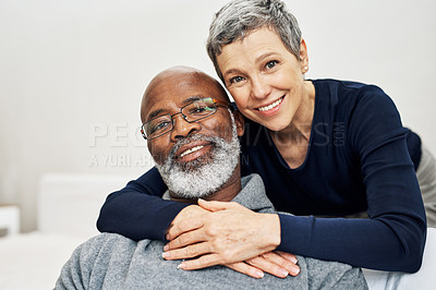 Buy stock photo Cropped portrait of an affectionate senior couple relaxing on the sofa at home