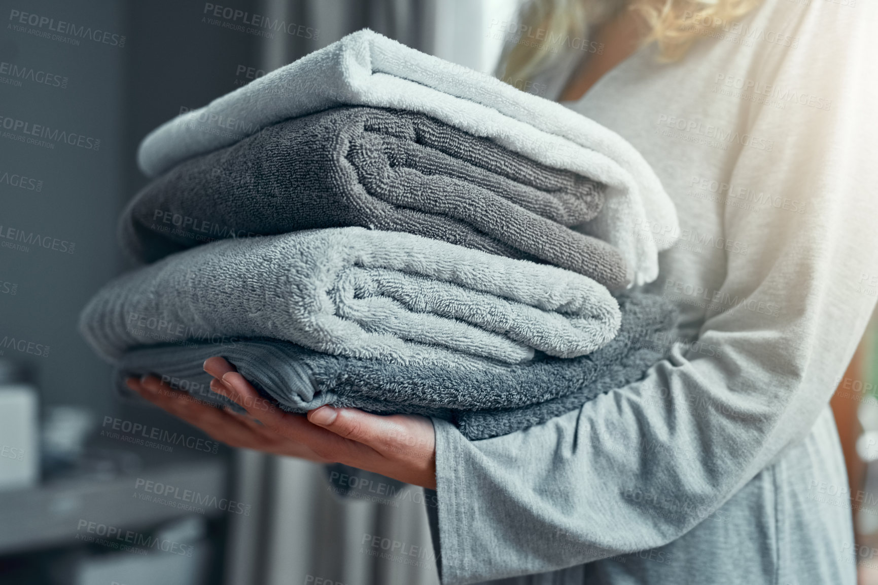 Buy stock photo Laundry, cleaning and a woman with a pile of towels in her home for hygiene or a spring clean day. Hospitality, service and a female cleaner carrying a stack of fresh or clean fabric in a hotel room