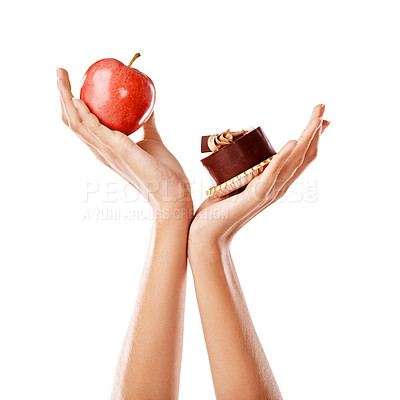Buy stock photo Woman, hands and food with apple or sweet for health, wellness and balance in studio.  Female person, deciding fruit and candy for natural, organic and diet to prevent of diabetes on white background