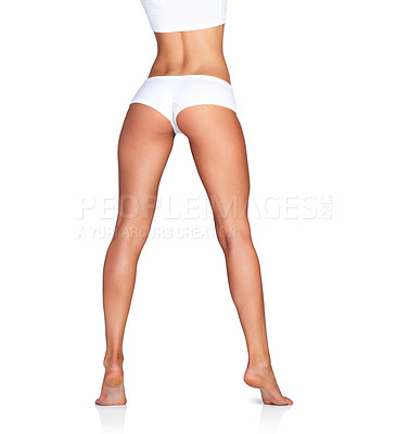 Buy stock photo Woman, legs and skincare rear view on mockup in studio for grooming, smooth and soft on white background. Feet, leg and girl model relax in underwear for skin, glow or luxury wellness while isolated