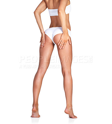 Buy stock photo Studio shot of an unrecognizable young woman in her underwear posing against a white background