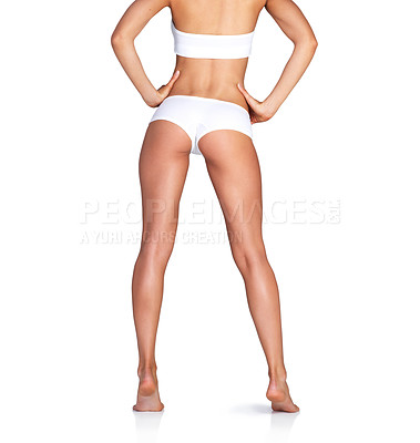 Buy stock photo Studio shot of an unrecognizable young woman in her underwear posing against a white background