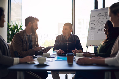 Buy stock photo Shot of a group of motivated business people having a meeting and discussion in a boardroom