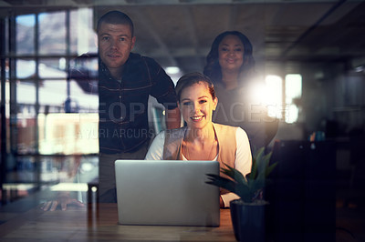 Buy stock photo Portrait of a group of work colleagues working together on a laptop and exchanging ideas in the office while looking into the camera