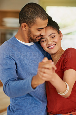 Buy stock photo Shot of a happy young couple dancing together at home