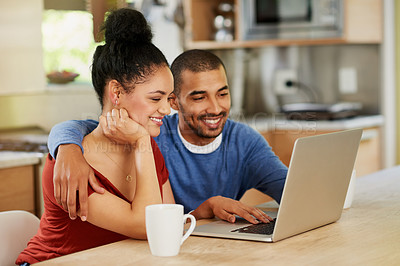 Buy stock photo Shot of a happy young couple using a laptop together at home