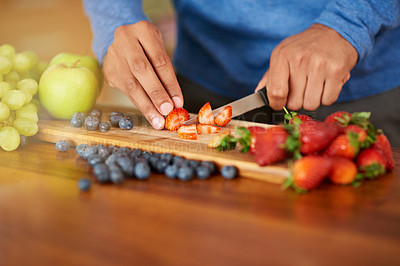 Buy stock photo Cropped shot of a man preparing a healthy and fruity snack