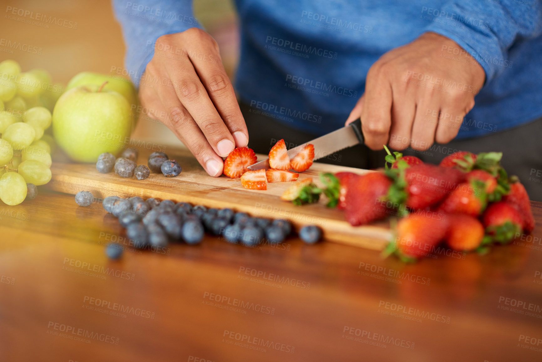 Buy stock photo Cropped shot of a man preparing a healthy and fruity snack